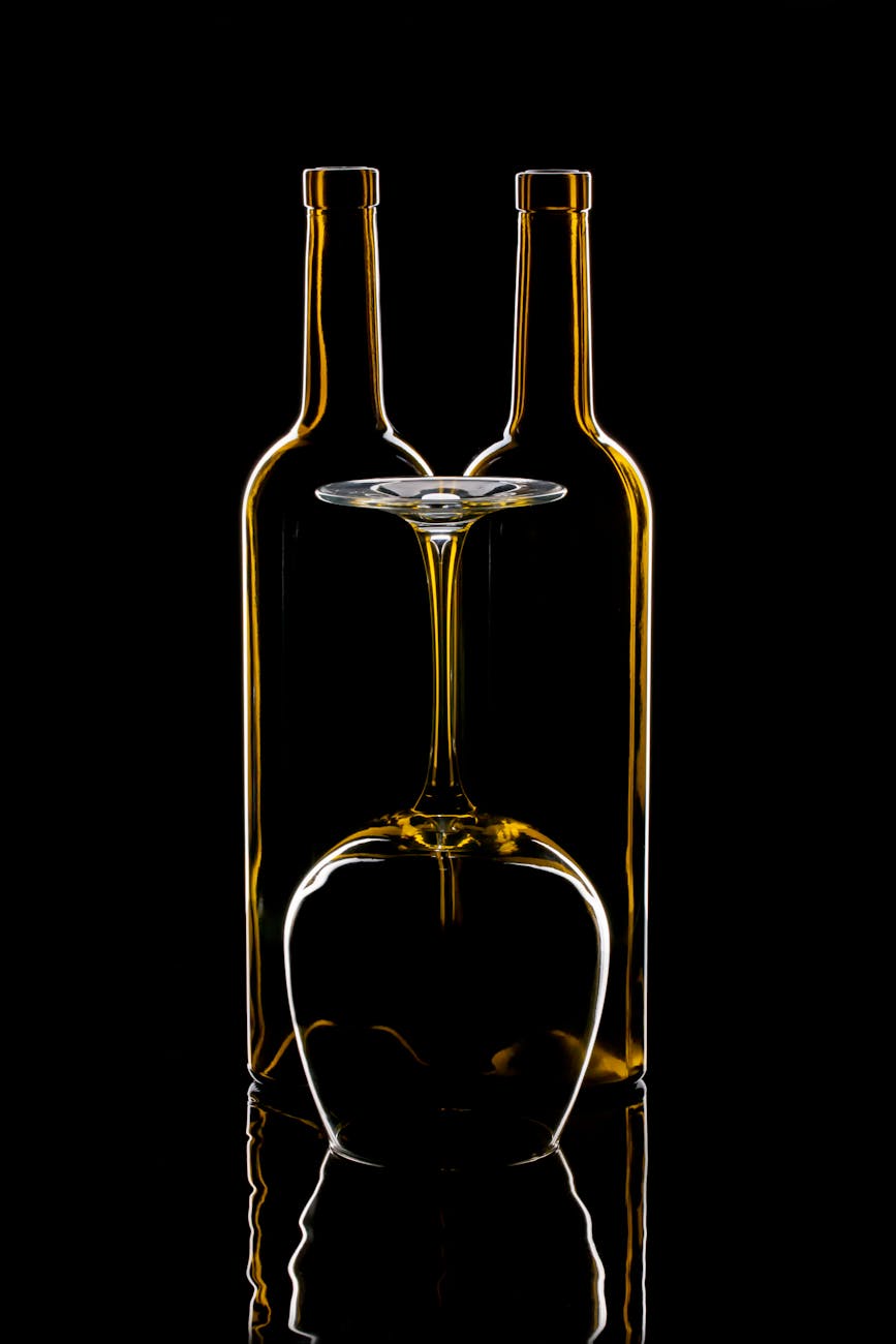 artistic still life of wine bottles and glass