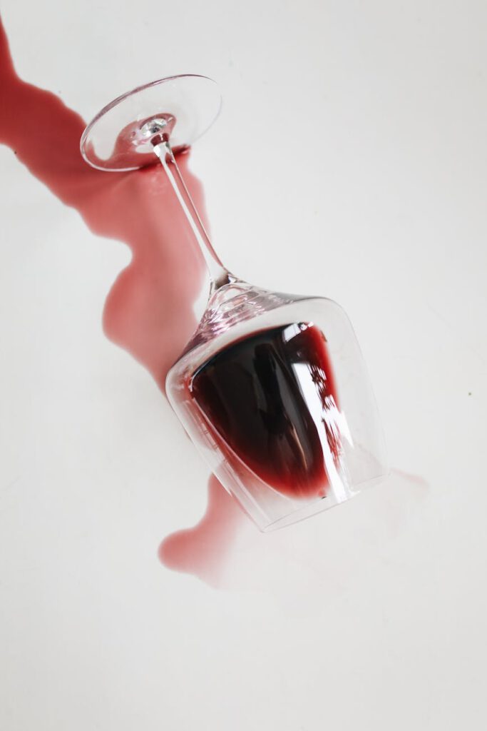 photo of wine glass with red liquid